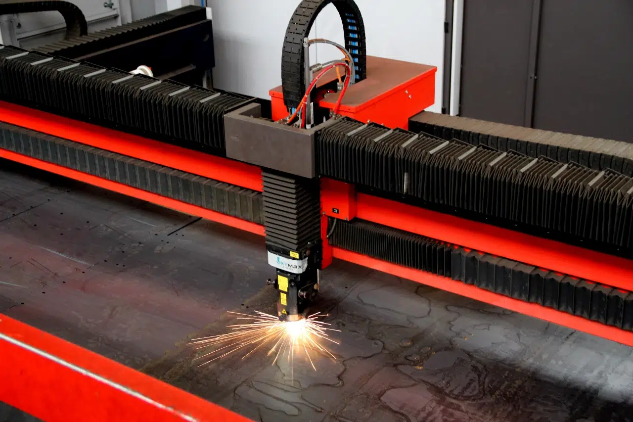 Machine de découpe laser industrielle en action sur une plaque métallique