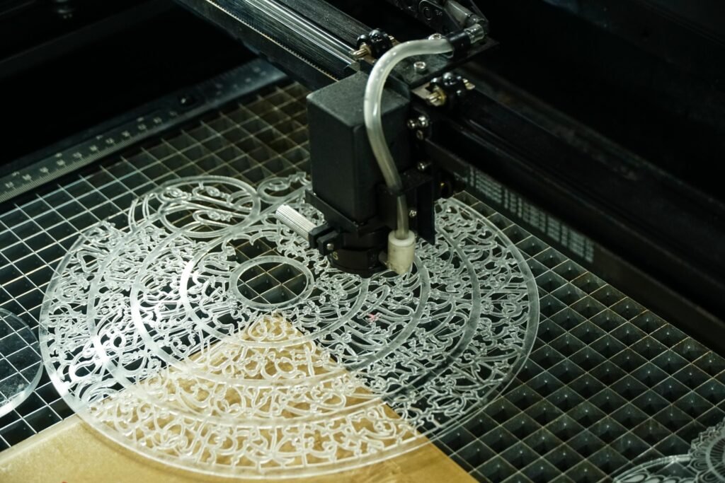 Machine de découpe laser en train de travailler sur une feuille d'acrylique